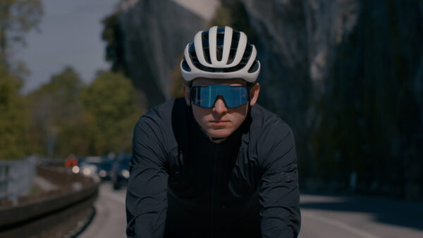 Cyclist is riding on the bicycle with helmet and sunglasses